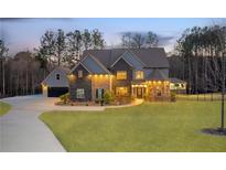 Stunning two-story home featuring a well-manicured lawn and a charming turret entrance at 149 Avalon Way, Sharpsburg, GA 30277