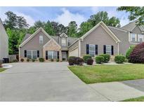 Charming two-story home with landscaped yard and welcoming curb appeal, complemented by a well-maintained driveway at 2842 Sedgeview Ln, Buford, GA 30519