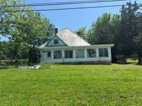 Charming single story home with large lawn, multiple paned windows and lush trees at 391 Rudy York Nw Rd, Cartersville, GA 30121