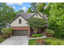 Charming two-story home with a brick and neutral siding exterior, attached two-car garage, and mature landscaping at 414 Silver Top Dr, Grayson, GA 30017