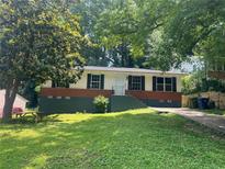 Charming single-story home with dark shutters, brick accents, and a lush front lawn at 3086 Lone Oak Sw Ave, Atlanta, GA 30354