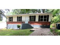 Charming single-story home featuring a brick foundation and well-maintained front yard at 3086 Lone Oak Sw Ave, Atlanta, GA 30354