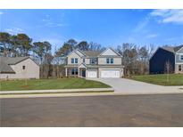 New construction home with a three-car garage and well-manicured lawn at 124 Felicity Pike, Locust Grove, GA 30248