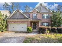 Charming two-story brick home with a well-maintained lawn and attached two-car garage at 4889 Arbor View Nw Pkwy, Acworth, GA 30101