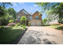 Beautiful two-story home with a well-manicured lawn and a large driveway at 176 Oakland Way, Dallas, GA 30157