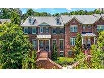 Charming red brick townhouse with manicured landscaping and traditional architectural details at 2828 Broughton Se Ln, Atlanta, GA 30339