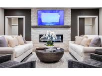 A beautifully designed living room featuring a modern fireplace and comfortable seating at 3351 Orwell Way # 2305, Cumming, GA 30041