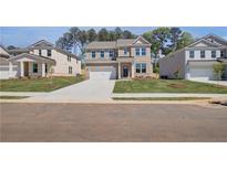 Beautiful two-story brick home with a large driveway and well-manicured lawn at 623 Leafy Branch Way, Mcdonough, GA 30253