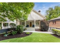 Charming home with a welcoming front porch, manicured lawn, and mature trees at 1068 Shelby Se Pl, Atlanta, GA 30316