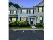 Charming home featuring blue shutters and trim, a well-kept lawn, and ample parking spaces at 10900 Wittenridge Dr # H8, Alpharetta, GA 30022