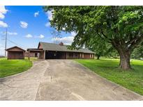 Spacious driveway leading up to a charming home with mature trees in the front yard at 3105 Hamilton Mill Rd, Buford, GA 30519