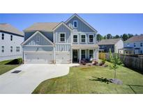 Charming two-story home with a manicured lawn, two-car garage, and inviting front porch at 42 Citrine Way, Acworth, GA 30101