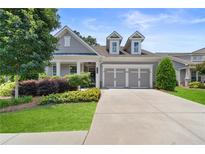 Charming single-Gathering home featuring a manicured lawn, attached two-car garage, and welcoming curb appeal at 519 Rosemont Ave, Canton, GA 30115