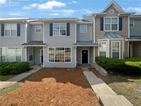 Charming townhome featuring updated exterior paint and landscaping at 105 Odyssey Turn, Conyers, GA 30012