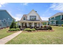 Charming two-story home with a welcoming front porch and beautifully landscaped front yard at 4044 Andover Cir, Mcdonough, GA 30252