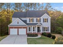 Charming two-story home featuring a brick facade, a well-manicured lawn, and a two-car garage at 139 Thunder Ridge Ln, Acworth, GA 30101