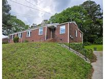 Charming brick home with a well-maintained lawn and mature trees at 1753 Cahoon Sw St, Atlanta, GA 30310