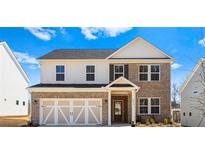 Charming two-story home with brick and siding, complemented by a two-car garage and well-manicured landscaping at 1619 Tide Mill Road, Cumming, GA 30040