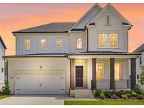 Beautiful two-story home featuring a brick facade, covered porch, and a two-car garage at 784 Keystone Dr, Woodstock, GA 30188