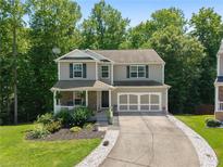 Charming two-story home with a well-manicured lawn and an attached two-car garage at 3420 Griffin Way, Cumming, GA 30040