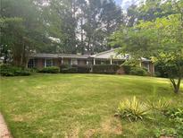 Charming single-story home with manicured lawn and mature trees offering great curb appeal at 3794 W Hayward Ct, Tucker, GA 30084