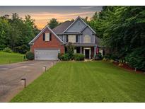 Charming two-story brick home with a manicured lawn and attached two-car garage at 5928 Edenfield Nw Dr, Acworth, GA 30101
