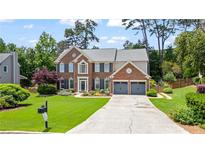 Charming two-story brick home with a manicured lawn and a two-car garage at 8045 Depford Way, Cumming, GA 30041