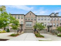 Charming townhomes with brick exteriors, private garages, and landscaped front yards in a vibrant neighborhood at 3 Hundley Ln, Roswell, GA 30076