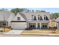 Charming single-Gathering home boasts a welcoming front porch, attached two car garage, and manicured lawn at 3772 Tielman St, Snellville, GA 30078
