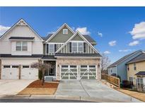 Charming two-story home showcasing a two-car garage and a well-maintained front yard with a beautiful blue sky backdrop at 326 Oakview Way, Canton, GA 30114