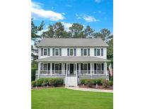 Charming two-story home featuring a large front porch, beautiful landscaping, and a welcoming atmosphere at 21 Picketts Ridge Ln, Acworth, GA 30101