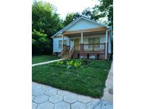 Charming single-story home with a welcoming front porch and meticulously landscaped front yard at 1167 Oakland Sw Dr, Atlanta, GA 30310