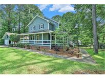Charming two-story home boasts a welcoming front porch and beautifully landscaped yard at 3392 Inns Brook Way, Snellville, GA 30039