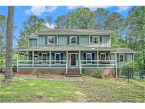 Charming two-story home with a welcoming front porch and well-maintained landscaping at 3392 Inns Brook Way, Snellville, GA 30039
