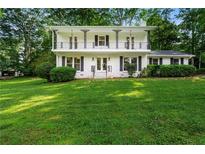Charming two-story home with a second story balcony and a lush green lawn at 5290 River Mill Cir, Marietta, GA 30068