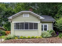Charming single-Gathering home featuring a covered front porch, painted brick foundation, and lush landscaping at 1424 Van Epps Se Ave, Atlanta, GA 30316