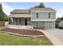 Charming two-story home featuring a landscaped front yard and a welcoming front porch at 1491 Black Hickory Pl, Norcross, GA 30093