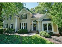 Charming two-story home with a brick facade and beautifully landscaped front yard at 1328 Amberwood Dr, Woodstock, GA 30189