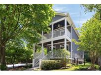 Charming two-story home featuring double porches, white railings, gray siding, and professional landscaping at 1003 North Ne Ave, Atlanta, GA 30306