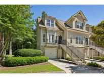 Charming townhome exterior with manicured landscaping, stairs, and one-car garage at 3150 Stonewyck Pl, Decatur, GA 30033