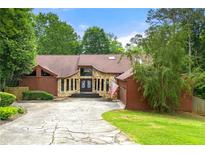 Charming single-story home with stone accents, mature trees, and a spacious driveway at 4710 Misty Lake Ne Ct, Kennesaw, GA 30144