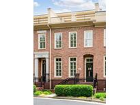 Charming brick townhome with a rooftop deck, front garden, and welcoming entrance at 1211 Riverscall Ln, Atlanta, GA 30339