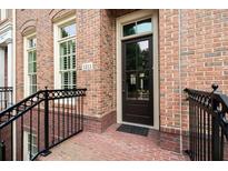 Charming brick home entrance with black metal railing, dark door with glass, and visible house number at 1211 Riverscall Ln, Atlanta, GA 30339