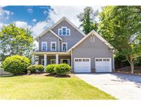 Charming two-story home with manicured lawn, two car garage, and welcoming curb appeal at 2167 Tilson Rd, Decatur, GA 30032