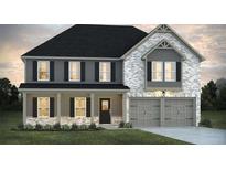 Charming two-story home featuring a brick and siding facade, covered porch, and an attached two-car garage at 246 Crabapple Rd, Mcdonough, GA 30253