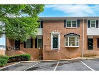 Charming brick townhome with black shutters, landscaping, and convenient parking at 6520 Roswell Rd # 48, Atlanta, GA 30328