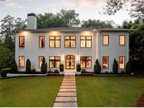 Stunning two-story home with a manicured lawn and elegant walkway leading to the front entrance at 4132 Carmain Ne Dr, Atlanta, GA 30342