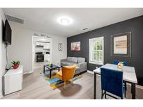 Bright living room features modern furnishings, colorful rug and decor, and open access to the kitchen at 2794 7Th Sw St, Atlanta, GA 30315
