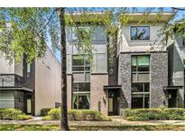 Modern townhouse with brick facade and large windows, surrounded by lush greenery at 710 Oakview Rd, Decatur, GA 30030