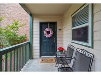 Inviting porch with chairs, wreath on door, and a view of the natural surroundings at 212 Brittany Ct, Duluth, GA 30096